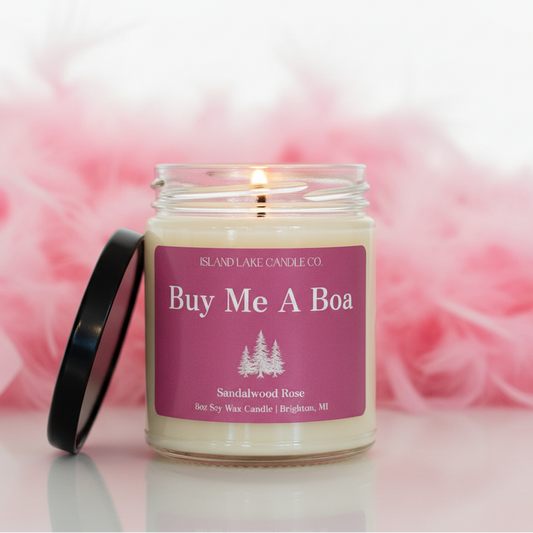 Buy Me A Boa candle by Island Lake Candle Co. on white background with pink feather boa in background